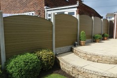 Natural gravel boards in existing concrete posts wit convex tops.